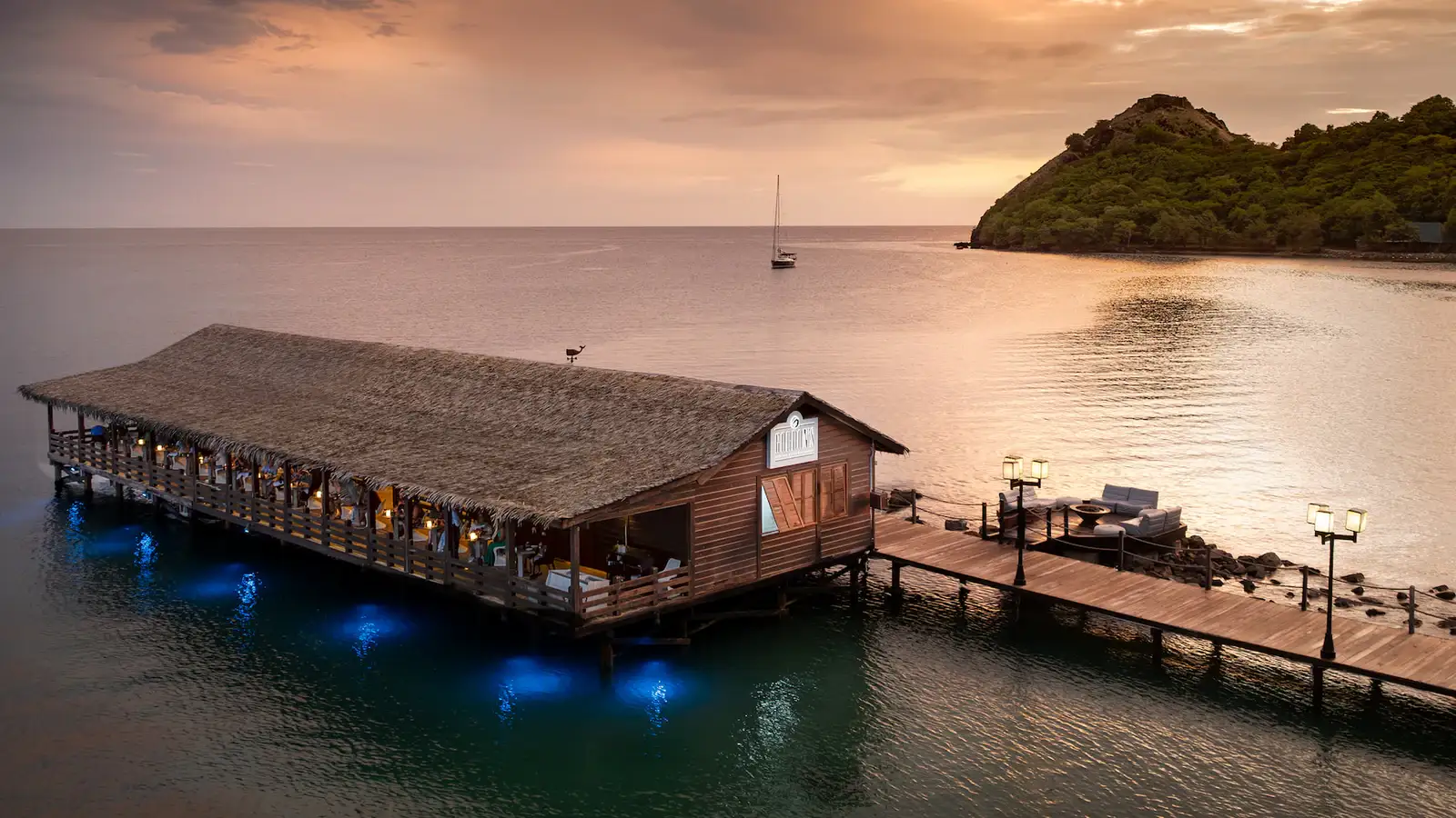 Elegant oceanfront dining at Sandals Grande St. Lucian with the Pitons in view
